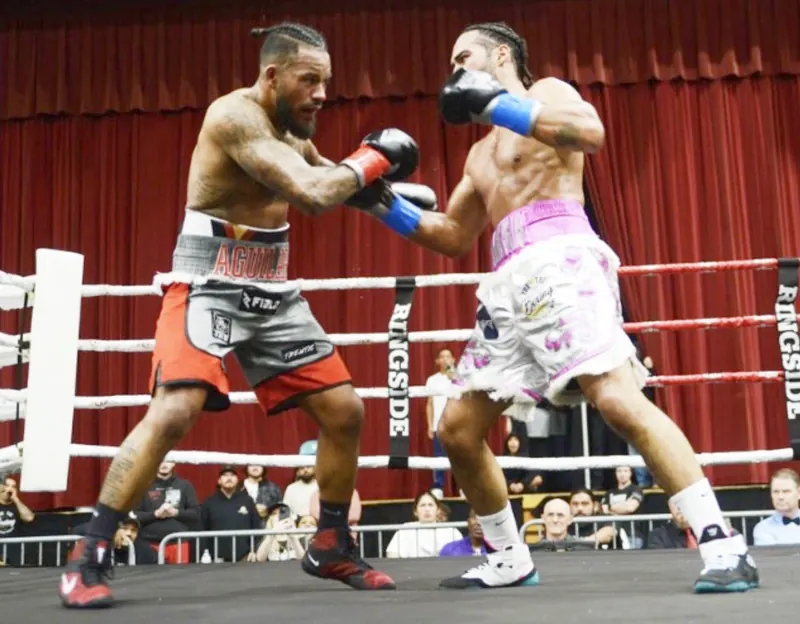 Jeremiah Sierra in white and pink SIERRA trunks throwing a right hand at Arena Wars